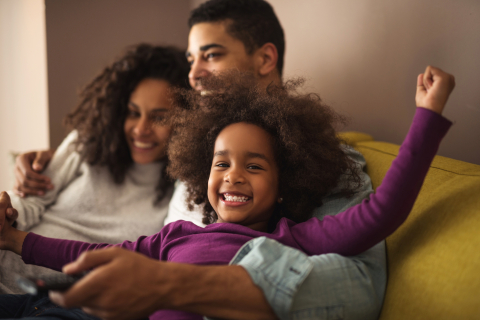 Family laughing on couch
