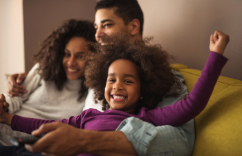 Family laughing on couch